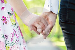 Holding hands close-up. Couple in love dating