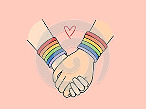 Holding hands with lgbt bracelets symbolizing love between gays or lesbians or tolerance
