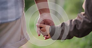 Holding hands, parent or child hiking in forest to relax on holiday vacation together in nature. Kid closeup, travel or