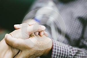 Holding hands for support with senior man  using medical equipment for inhalation with respiratory mask, nebulizer