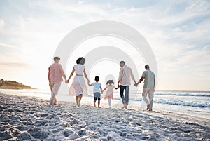 Holding hands, walking and back of big family at the beach for travel, vacation and adventure in nature. Love, freedom