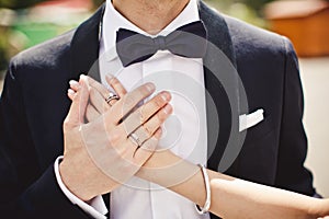 Holding hands with wedding rings