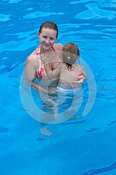 Holding Her Daughter in the Pool