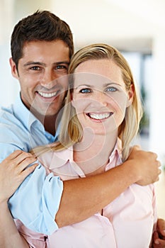 Holding her tight and never letting go. Romantic shot of a couple embracing intimately.