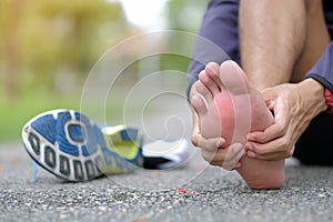 holding his sports leg injury, muscle painful during training