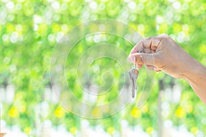 Holding house key in hand.Mortgage loan approval home loan and insurance concept.on white background
