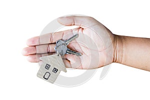 Holding house keys on house shaped keychain in front of a new ho