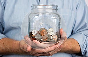 Holding A Jar Of Coins Money