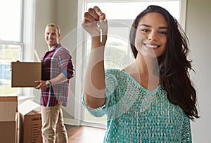 Holding the keys to their dream home. a young couple moving into their new home.