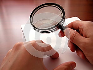 Holding a magnifying lens