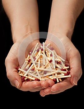 Holding matches on black background