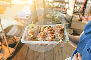 Holding mini Fried Mussels in Batter,Floating market