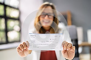 Holding Paycheck Or Payroll Check Or Insurance Cheque photo