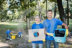 Holding placard with globe, save inscription