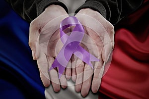 Holding purple domestic violence awareness ribbon