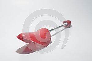 Red Plastic Shoe Tree on White Isolated Background