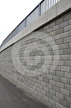 Holding a road notch of a bridge forecourt tunnel. retaining wall with concrete grouting is covered with fake, optically prettier photo