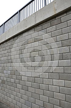 Holding a road notch of a bridge forecourt tunnel. retaining wall with concrete grouting is covered with fake, optically prettier