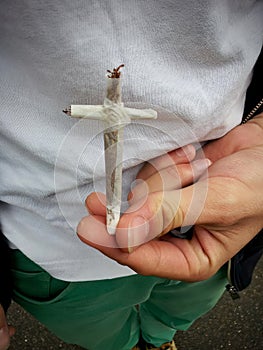 Holding a Rolled Cigarette in the Shape of a Cross: Power in the Hand