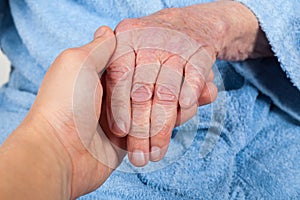 Holding senior woman`s hand