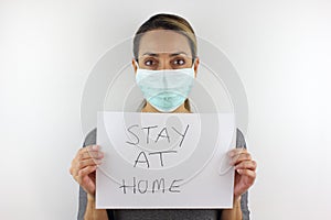 Holding a sign to stay at home