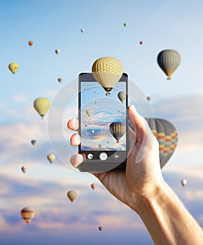 Holding smartphone with hot air balloons