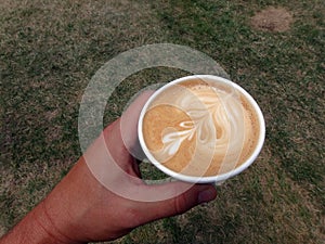 Holding a styrofoam cup of Cappuccino