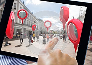 Holding tablet and Location pointer markers in city street