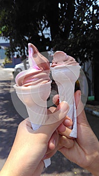 holding tightly to the ice cream cone