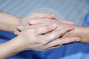 Holding Touching hands Asian senior or elderly old lady woman patient with love, care, helping, encourage and empathy.