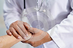Holding Touching hands Asian senior or elderly old lady woman patient with love, care, helping, encourage and empathy at hospital.