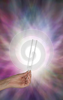 Holding Tuning Fork in Resonating Energy Field