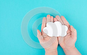 Holding a white cloud in the hand, empty copy space for text, blue background, communication and marketing concept,connection