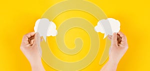 Holding a white cloud in the hand, empty copy space for text, yellow background, communication and marketing concept, being connec