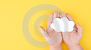 Holding a white cloud in the hand, empty copy space for text, yellow background, communication and marketing concept,connection