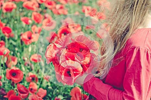 Holding wild red flowers
