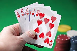 Holding the winning hand royal flush hearts selective focus