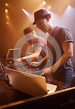 He holds the crowd in his hands. A DJ performing at a concert.