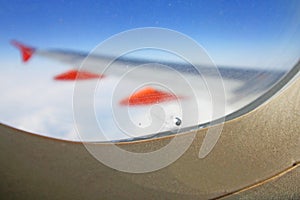 Hole in airplane window. The breather hole between inner and outer window of plane adjusts the air pressure drains the humidity. B photo
