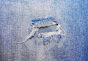 The hole on the blue jeans