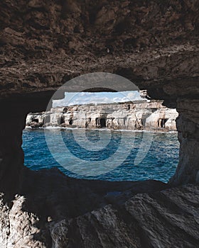 Hole in a cave with a beautiful view on sea near cape Greco in national park