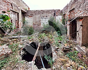 Hole on courtyard of an abandoned building