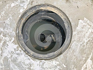 A hole of grease trap with the drain system around the house.