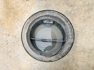 A hole of grease trap with the drain system around the house.