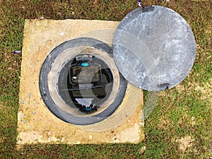 A hole of grease trap with the drain system around the house.