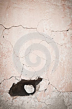 Hole in old cracked wall