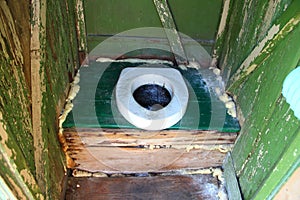 Hole of the old dirty country toilet, rural toilet inside