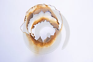 hole paper with edges burned on white background