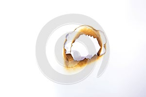 Hole paper with edges burned on white background