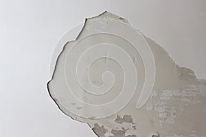 Hole in the plastered white ceiling